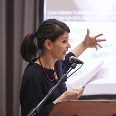 Researcher presenting their research from a podium